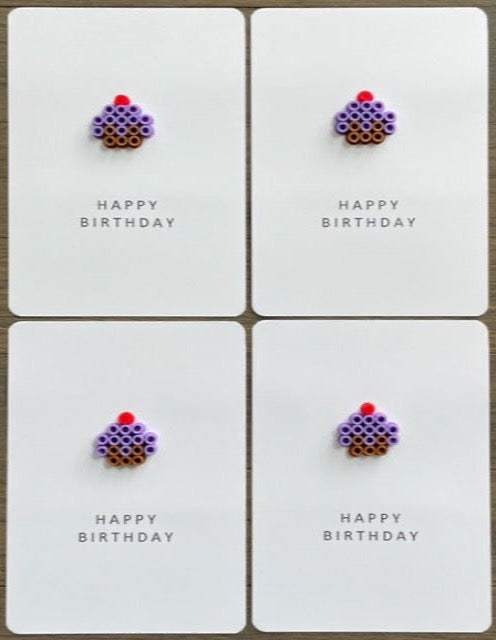 Picture of a set of 4 Happy Birthday cards that have a purple cupcake on each one