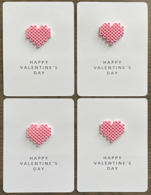 Picture of a set of 4 Happy Valentine's Day cards that each has a pink heart on it