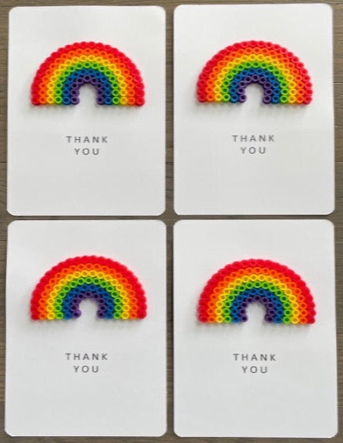 Picture of a set of 4 Thank You cards that have a large rainbow on each one.  The rainbow is red, orange, yellow, lime green, blue, purple
