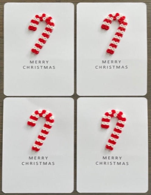 Picture of a set of 4 Merry Christmas cards. Each card has a red  and white candy cane on it