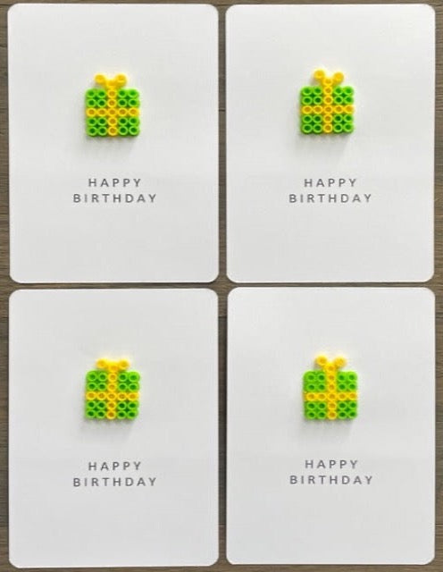 Picture of a set of 4 Happy Birthday cards that have a lime green with yellow ribbon gift on each one