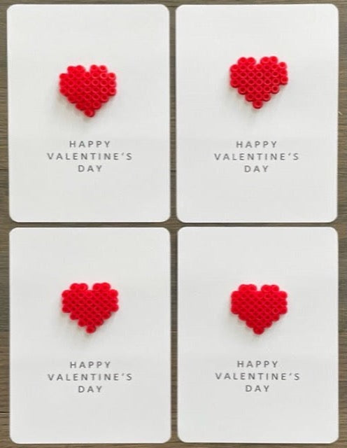 Picture of a set of 4 Happy Valentine's Day cards that each have a red heart on it