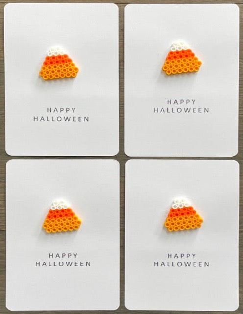 Picture of a set of 4 Happy Halloween cards each with a candy corn on it