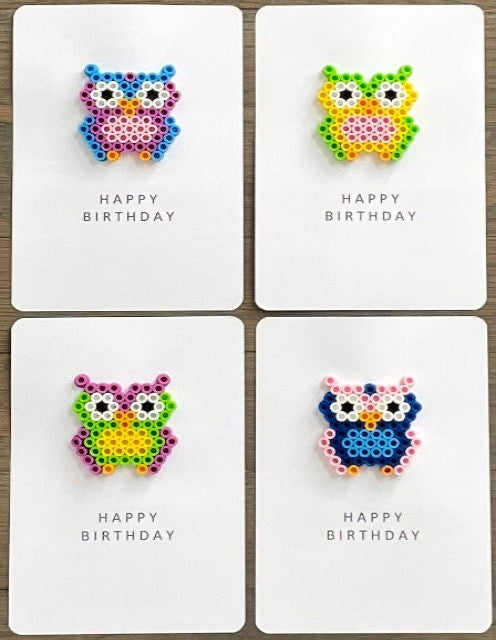Picture of a set of 4 owl Happy Birthday cards.  One has a blue, purple, and pink owl, one has a lime green, yellow, and pink owl, one is a purple, lime green, yellow owl, and one has pink, dark blue, light blue owl.