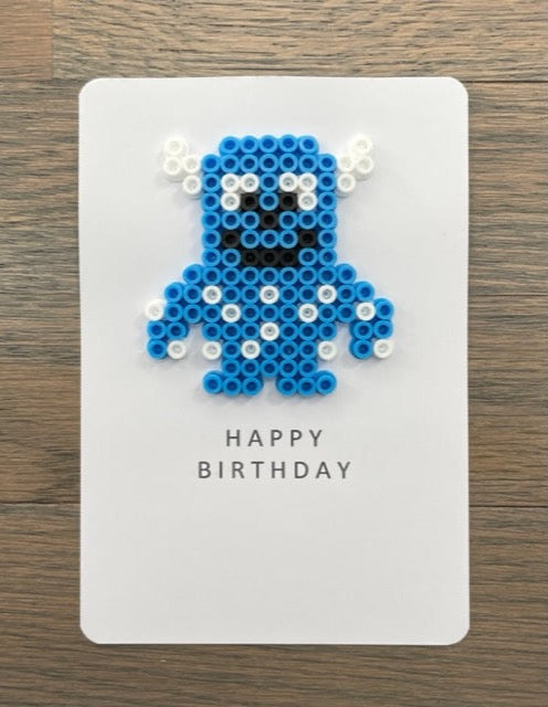 Picture of a Happy Birthday card with blue, white monster  on it