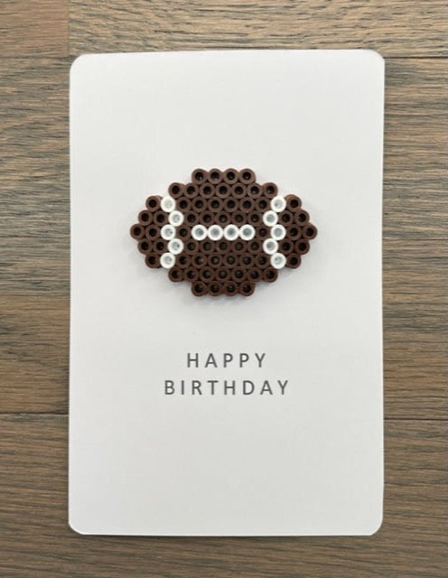 Picture of a Happy Birthday card that has a football on it