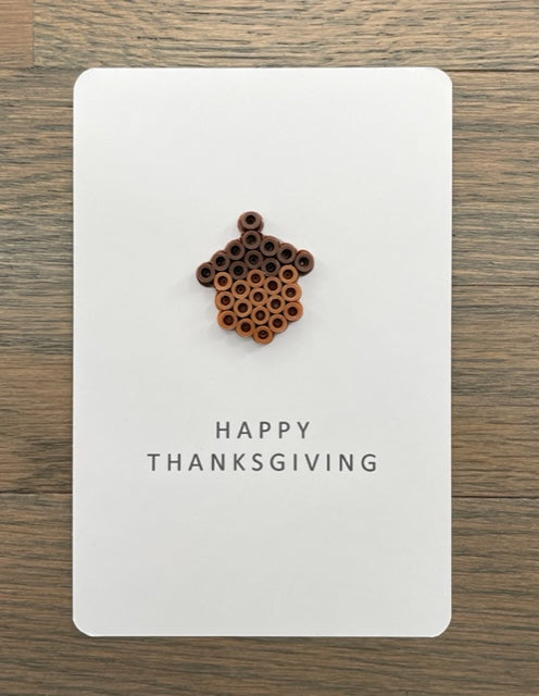 Picture of small light brown with dark brown top acorn Happy Thanksgiving card
