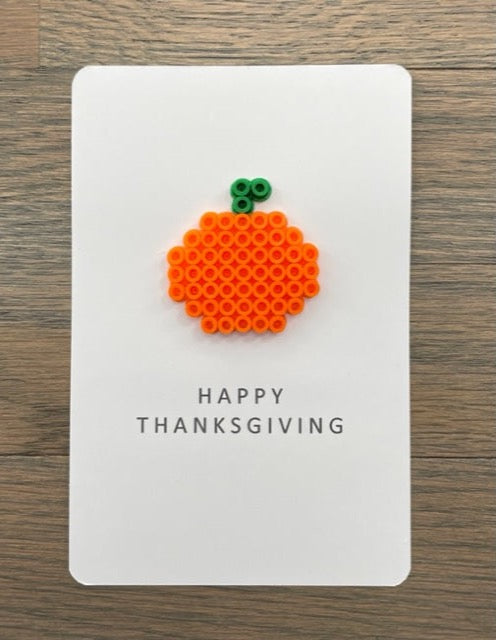 Picture of a Happy Thanksgiving card with an orange pumpkin on it