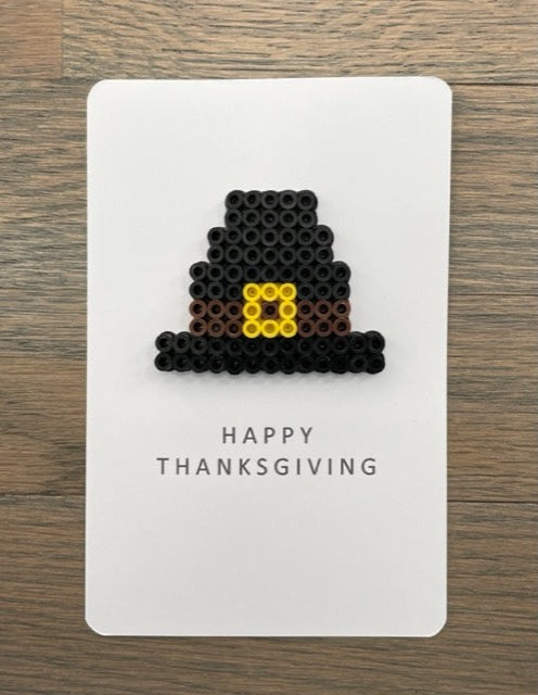 Picture of a Happy Thanksgiving card with black pilgrim hat on it