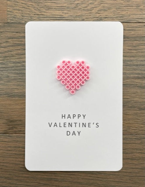 Picture of a Happy Valentine's Day card with a pink heart on it