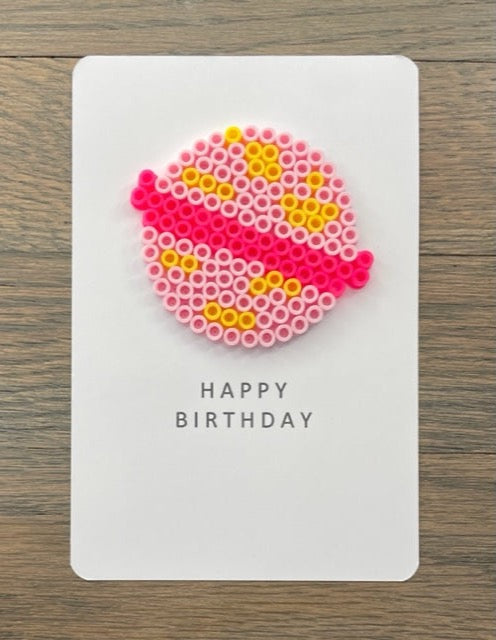 Picture of a Happy Birthday card with a pink and yellow planet on it 