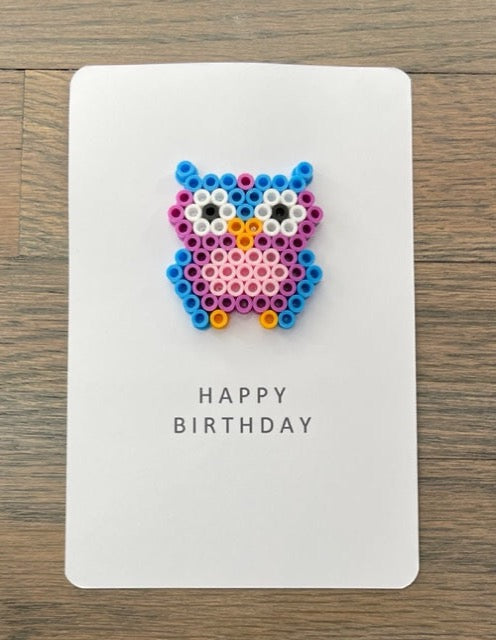 Picture of a Happy Birthday card with a blue, purple, and pink owl on it