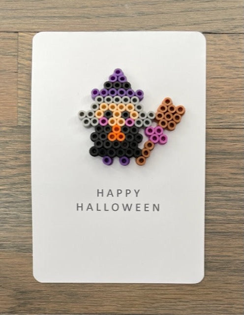 Picture of a Halloween card that has a witch on it