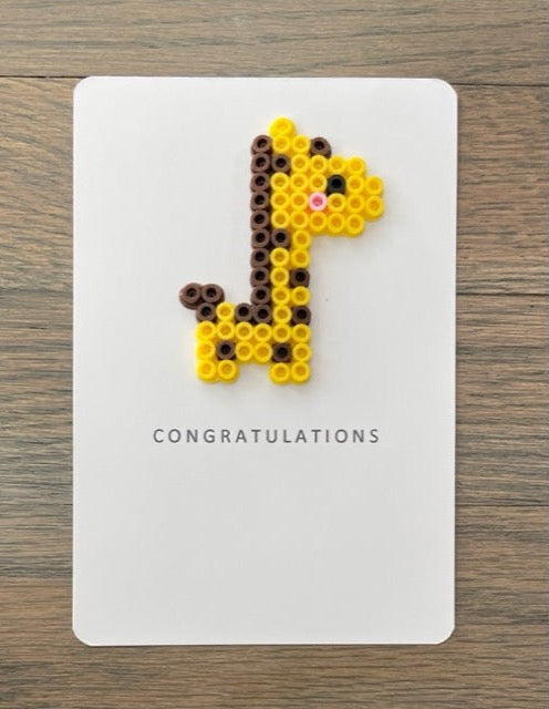 Picture of a Congratulations card with a yellow and dark brown giraffe on it