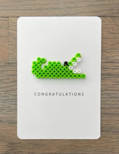 Picture of a lime green alligator congratulations card