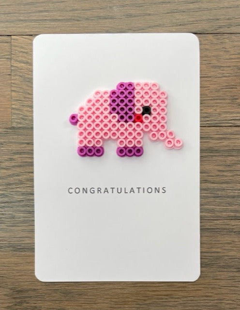 Picture of a congratulations card with a pink elephant on it