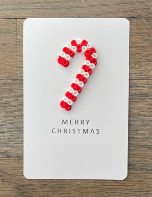Picture of a Merry Christmas card with red, white candy cane on it