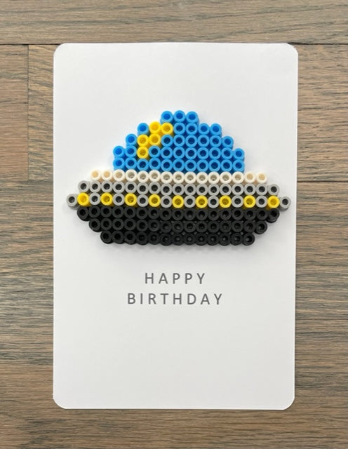 Picture of a Happy Birthday card with blue, black, gray, yellow spacecraft on it