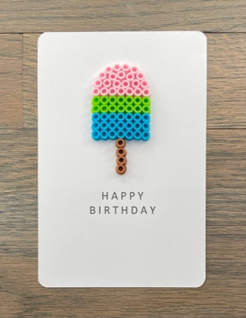 Picture of a Happy Birthday card with a pink, lime green, blue popsicle on it