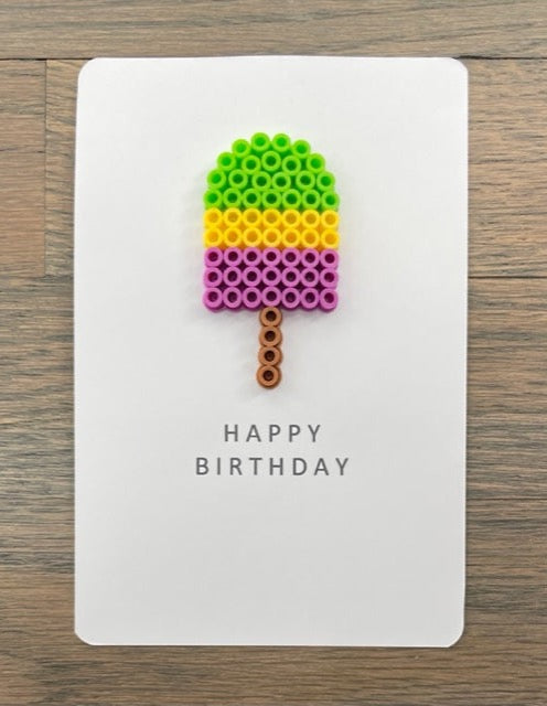 Picture of a Happy Birthday card with lime green, yellow, and purple popsicle on it