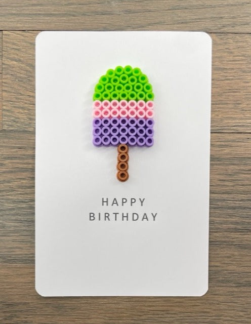 Picture of a Happy Birthday card with a lime green, pink, and purple popsicle on it
