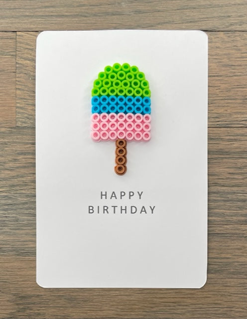 Happy Picture of a Birthday card with a lime green, blue, and pink popsicle on it