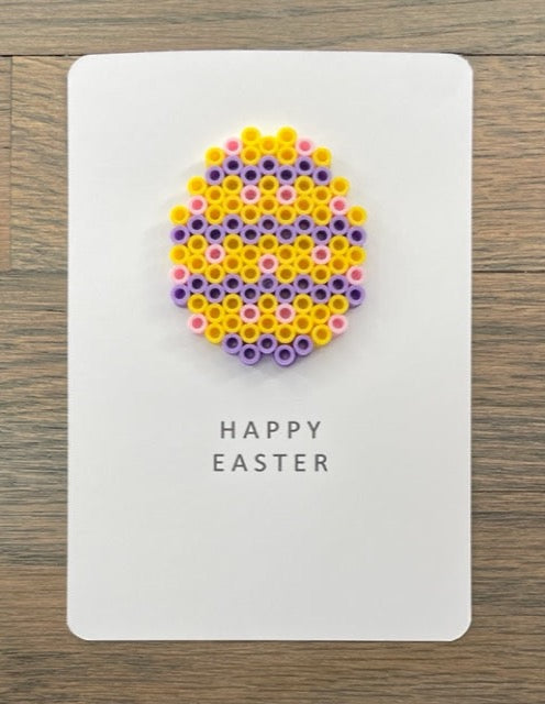 Picture of a Happy Easter card that has a yellow, purple, pink egg on it