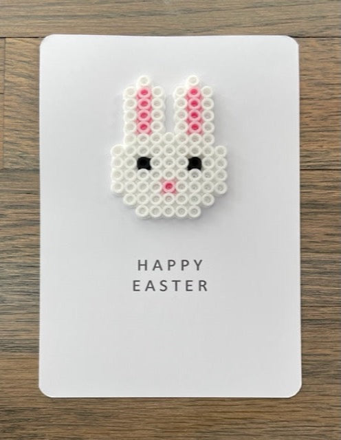 Picture of a Happy Easter card with a white bunny face on it