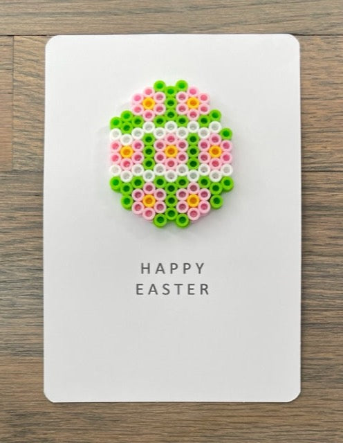 Picture of a Happy Easter card with a lime green, pink, yellow and white  Easter egg on it