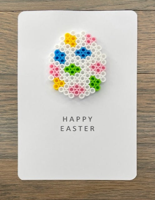 Picture of a Happy Easter card with a lime green, white, yellow, blue, and pink Easter egg on it