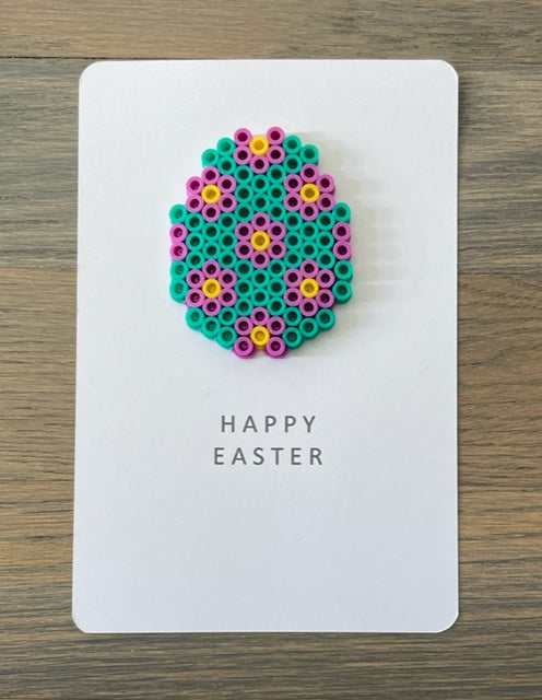 Picture of a Happy Easter card that has a teal, purple, yellow egg on it