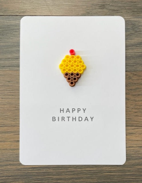 Picture of a Happy Birthday card that has a yellow ice cream cone on it