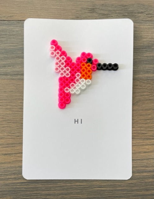 Picture of a card to say hi that has a pink, orange and white hummingbird on it