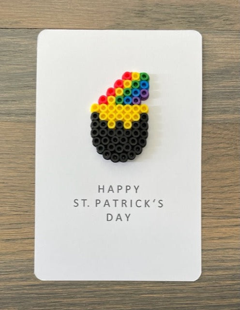 Picture of a Happy St. Patrick's Day card that has a pot of gold with a rainbow coming out of it on the card