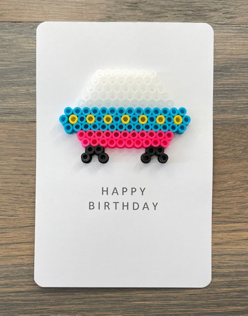 Picture of a Happy Birthday card with blue, pink, yellow spacecraft on it