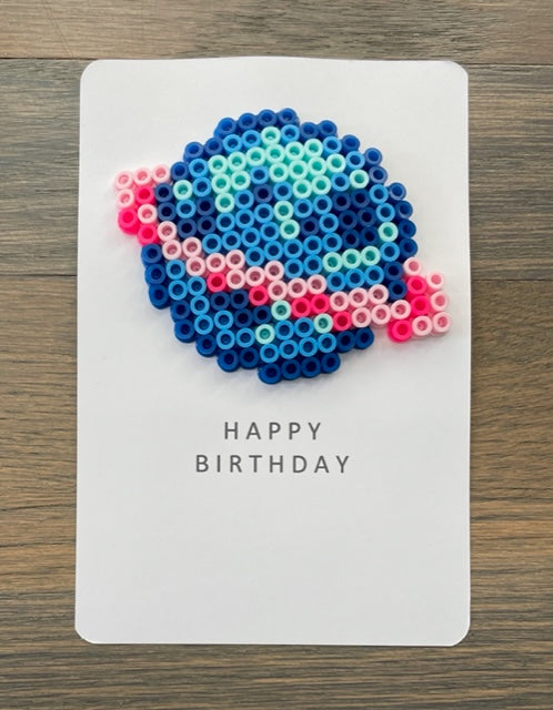 Picture of a Happy Birthday card with blue and pink planet on it