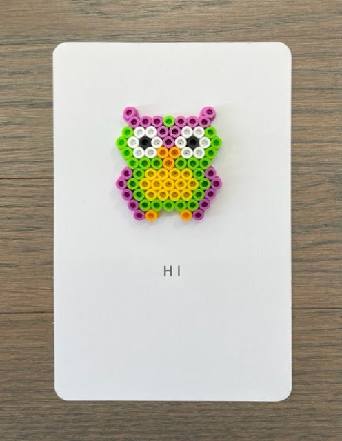 Picture of a Hi card with a purple, lime green, yellow owl on it