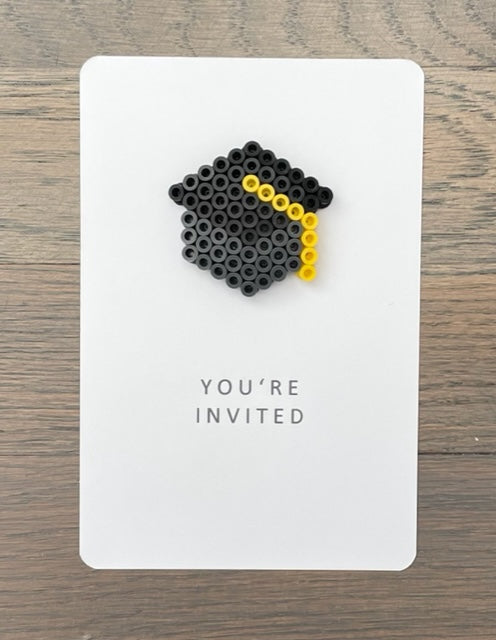 Picture of customizable graduation party invitation.  The front says You're Invited and has a graduation cap on it that can be the color you want.  