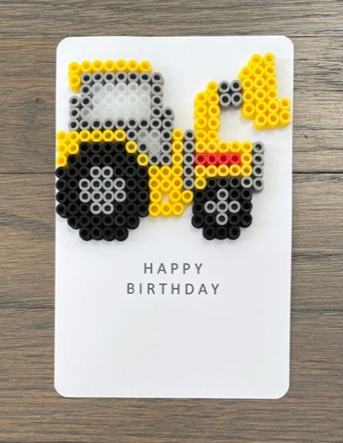 Picture of yellow construction loader on a Happy Birthday card.