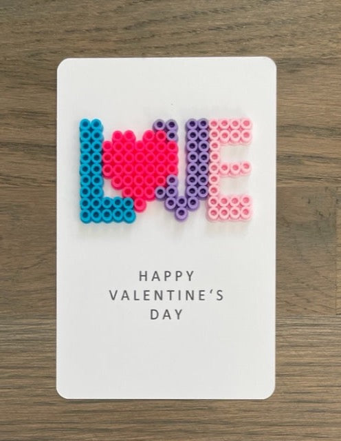 Picture of Love spelled out on the Happy Valentine's Day card.  The o is shaped as a heart.