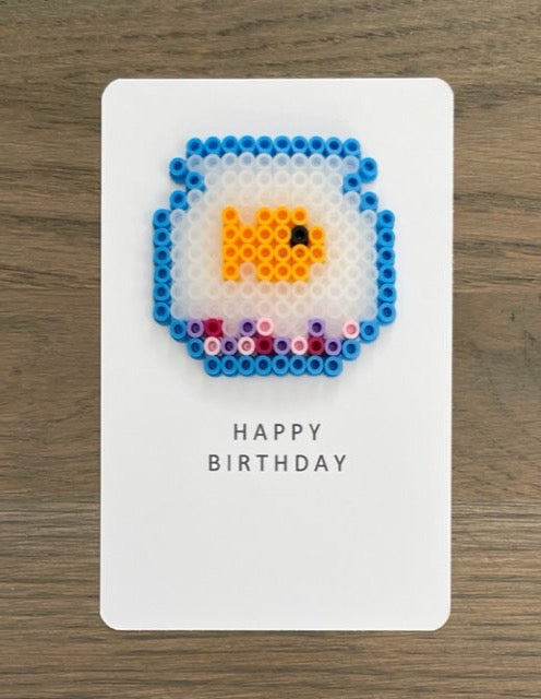 Picture of a Happy Birthday card with a fishbowl that has an orange fish in it.