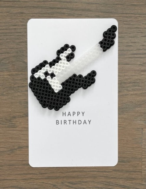 Picture of a black and white electric guitar on a birthday card.